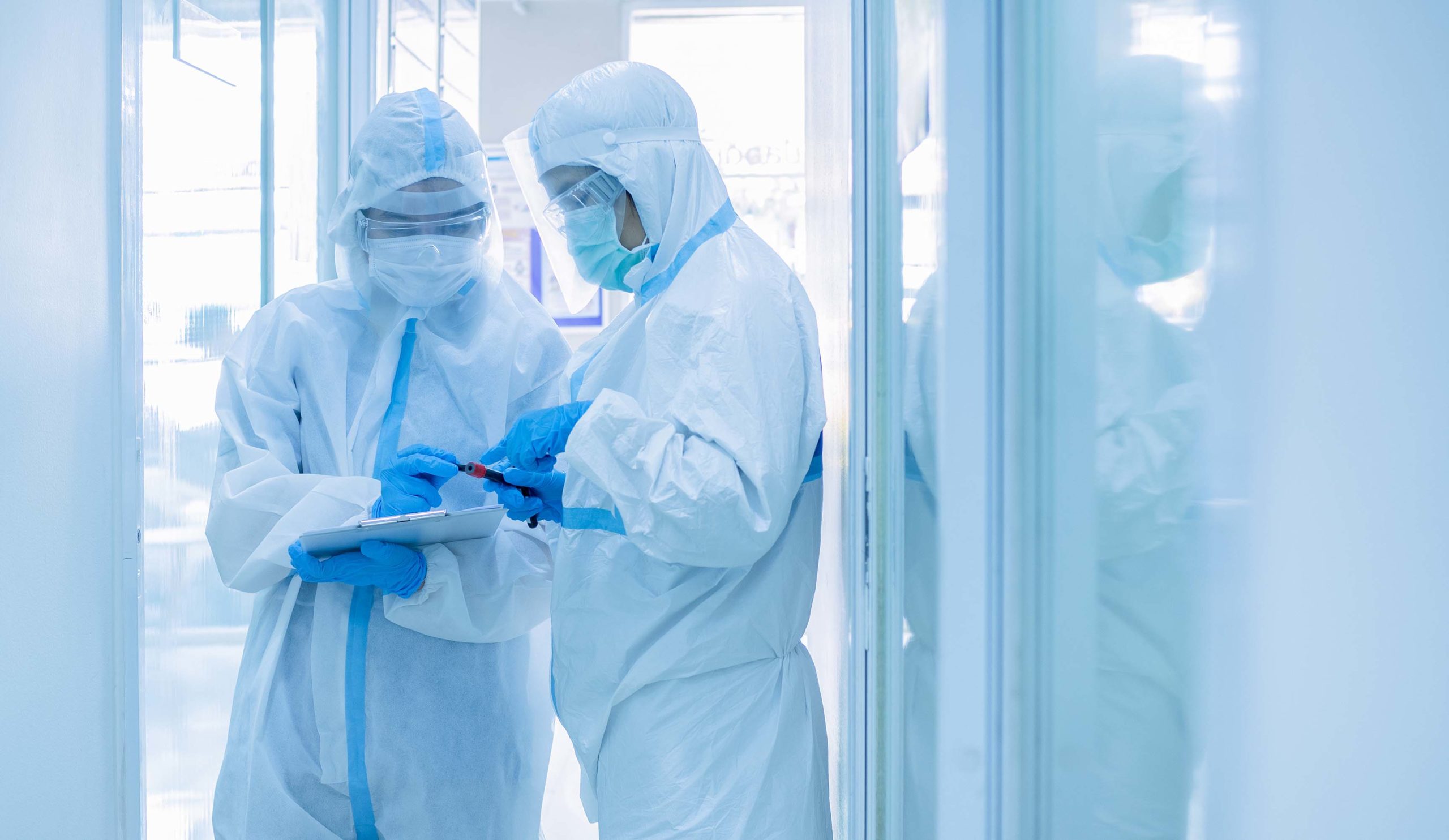 2 doctors in hazmat suits checking results